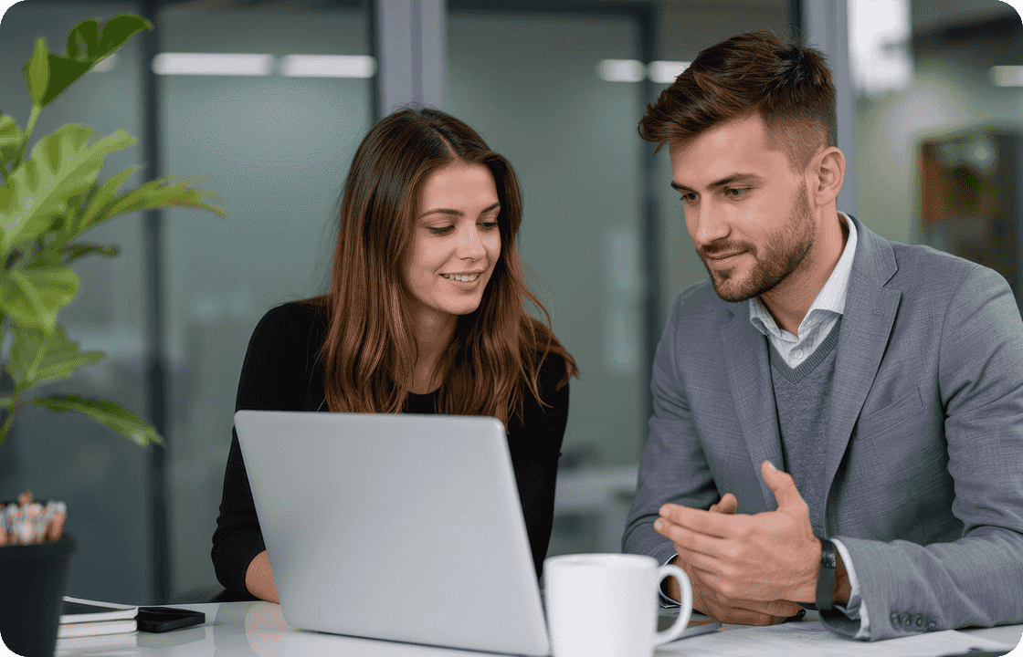 Two professionals in business attire collaborate on a laptop, representing ccMonet’s experts. They use AI - powered tools to offer SMEs bookkeeping, reconciliation, and customized workflow solutions, with tax and compliance specialists ensuring financial accuracy and regulatory adherence.