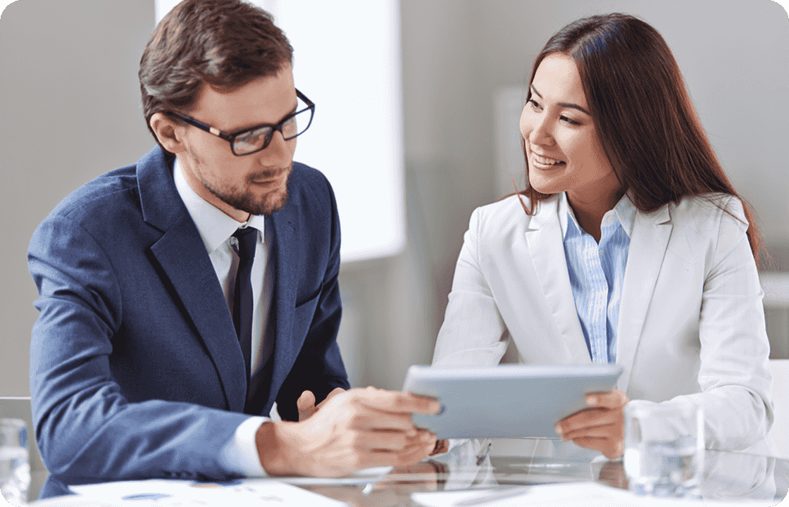 Two professionals in business suits collaborate on a tablet, representing ccMonet’s experts. They leverage AI - powered tools to offer SMEs bookkeeping, reconciliation, and customized workflow solutions, with tax and compliance specialists ensuring financial accuracy and regulatory adherence.