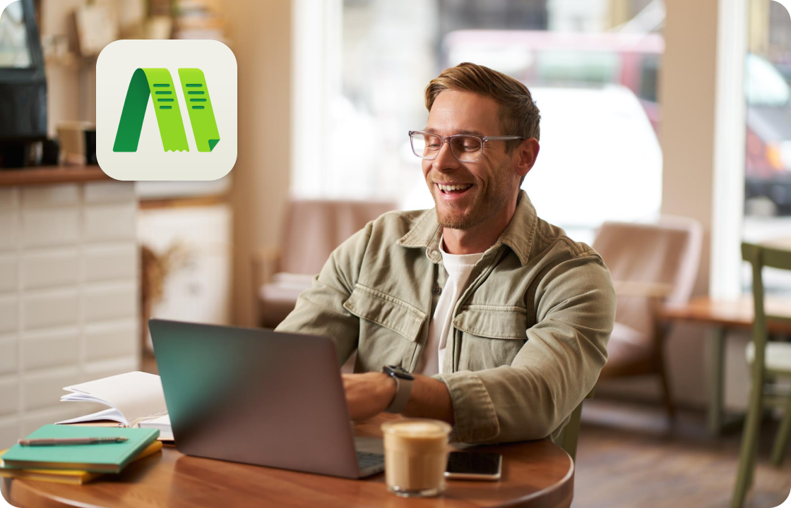 A man works on a laptop in a café, with ccMonet’s app icon shown. It represents SME owners (like café operators) using our AI - powered financial tools (bookkeeping, dashboards) and expert services (compliance, tax support) to manage business finances flexibly.