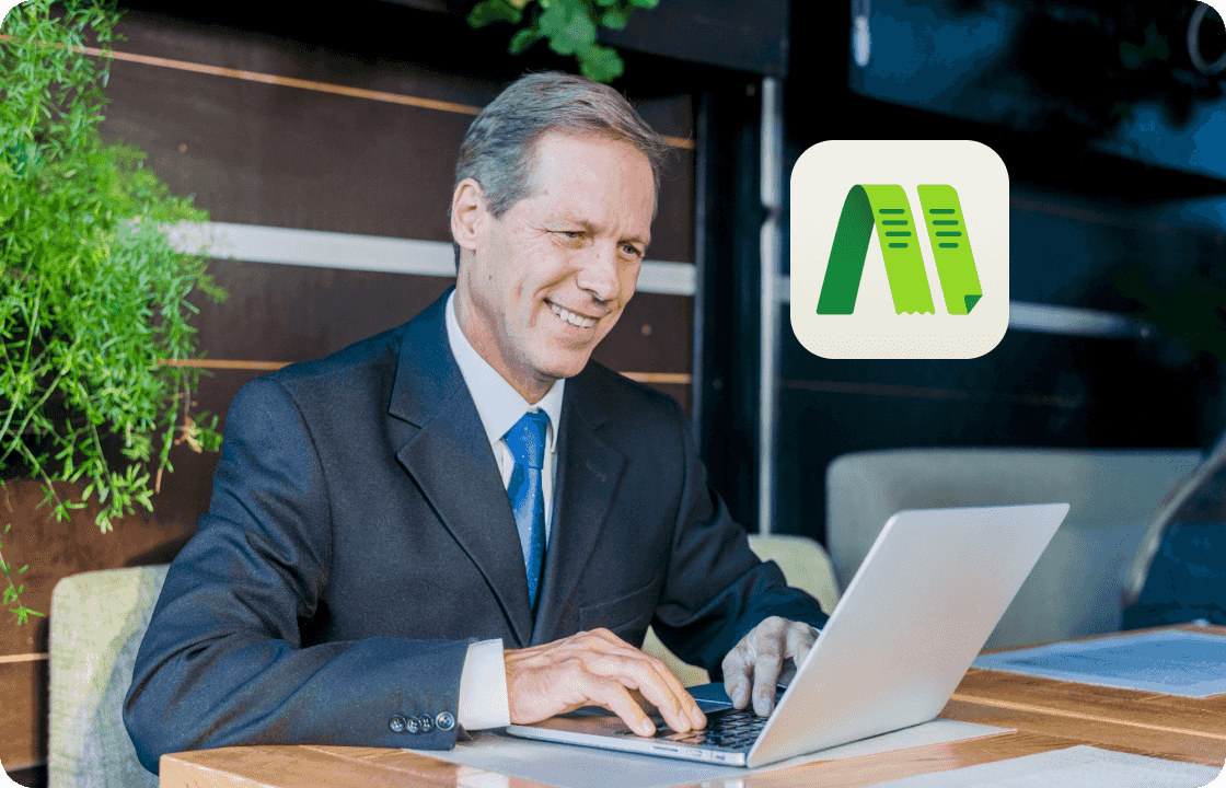 A man in a suit works on a laptop outdoors, with ccMonet’s app icon displayed. It represents SME leaders using our AI - powered financial tools (bookkeeping, dashboards) and expert services (compliance, tax support) to manage business finances flexibly and efficiently....
