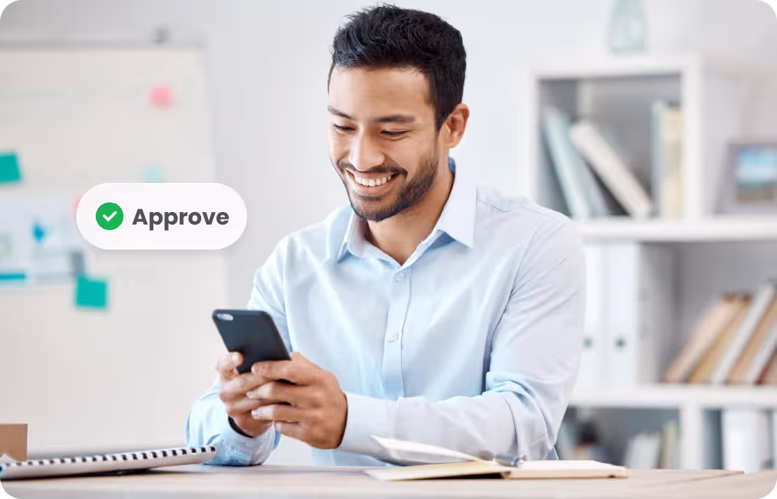 A man in a light - blue shirt uses a phone to approve tasks, with an “Approve”tag. It represents SME users of ccMonet—our AI - powered financial tools (bookkeeping, dashboards) and expert services (compliance, tax support) help them efficiently manage approval workflows and financial operations.